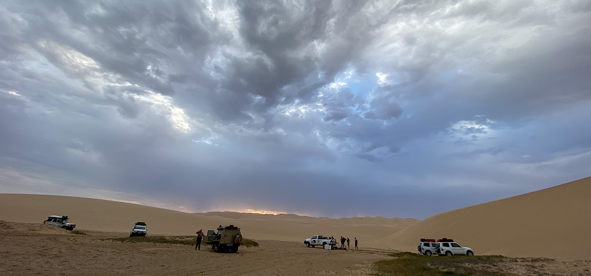 view of the campsite at Sandwich Harbour with stormy clouds above