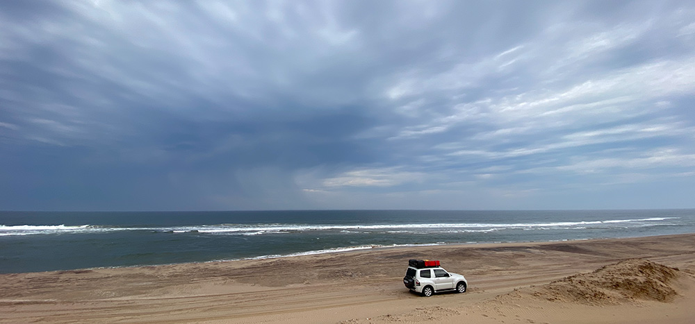 view of my Pajero with sea in the background and storm clouds out to sea